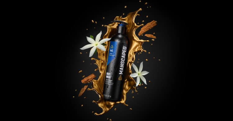 Persevere® UltraPremium Body Wash laying in a gold splash of flowers and and cedarwood chips