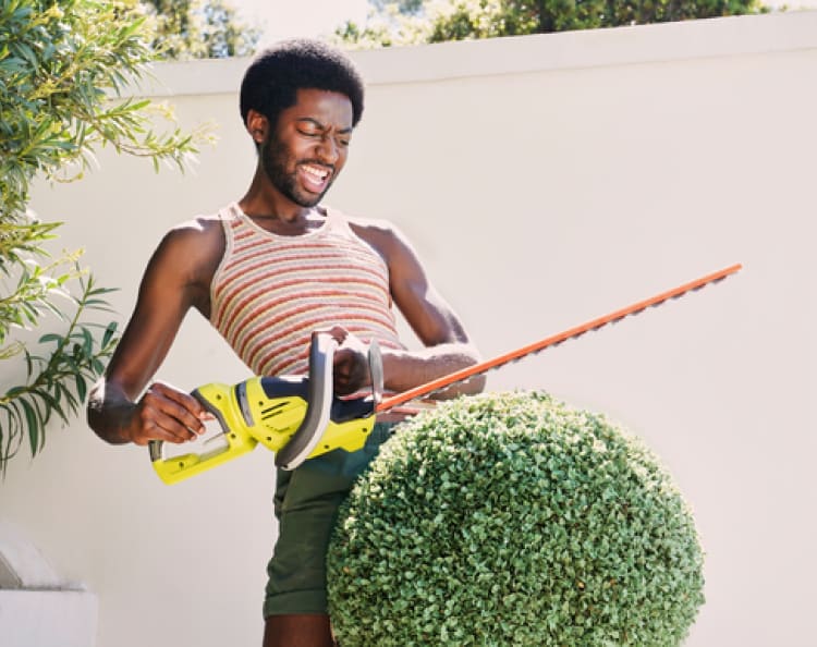 Man holding a Weed Trimmer