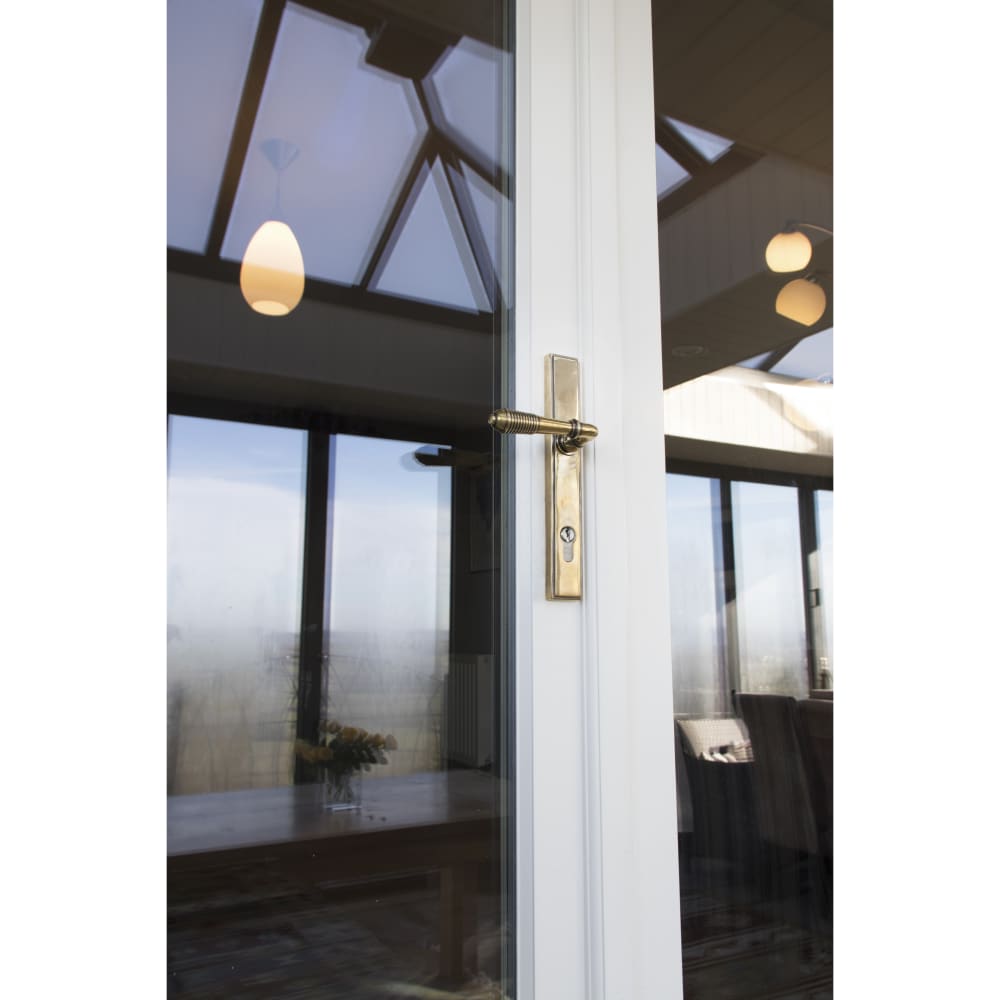 From The Anvil uPVC Reeded Slimline Multipoint Lock Door Handle - Euro - 92mm c/c - Aged Brass