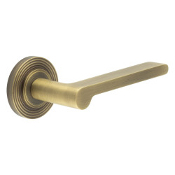 Burlington by Frelan Antique Brass Fire Rated Door Handles on Round Reeded Rose - Fitzrovia Range