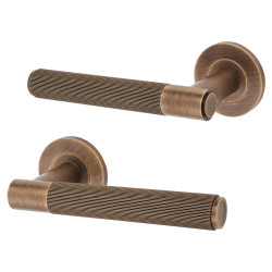 Alexander and Wilks Antique Brass Reeded Door Handles on Round Rose - Spitfire Range