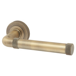 Jedo Antique Brass Fire Rated Knurled Door Handles on Round Rose - Midtown Range