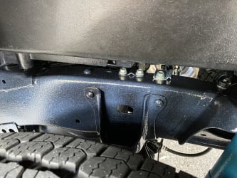 A zoomed in photo of a rear wheel well, showing the recent application of Fluid Film on the Tacoma’s frame.