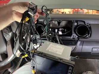 I pulled all of the kit’s wires from the driver’s footwell, up behind the dashboard, and am now holding them in my hand. On my lap is the uninstalled stereo.