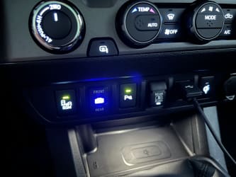 In the Tacoma with the dashboard put back togther, the kit’s front/rear camera switch—a three-way toggle—is installed next to the other factory switches.