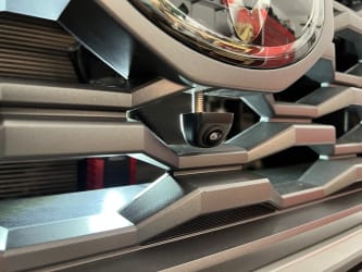 A zoomed-in view of the plastic grille, from the front, and I’ve partially inserted the camera into the tiny hole.