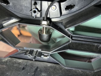 Another view of the partially inserted camera, but viewed from the back of the plastic grille.