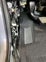 Inside the Tacoma, down by the left foot, I’ve removed the plastic cover which exposed a lot of factory wires and connectors and other important stuff.