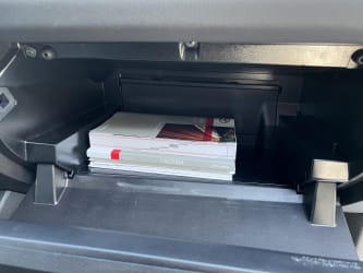 The interor of the Tacoma’s glove box without the organizer in place; the owner’s manuals have a lot of room to slide around.