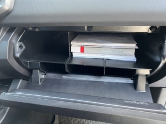 The glove box organizer, now inside my glove box, with the owner’s manuals tucked into one space that is just a little larger than the manuals themselves.