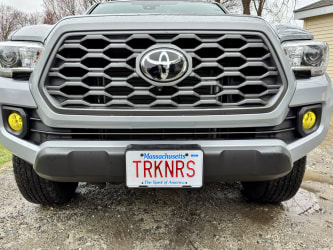 The front of my Tacoma; I’m bending down so the headlights are at eye-level, and the fog lights are a standard clear color.