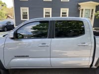 A zoomed in side-profile photo of the Tacoma, now with tint on the front windows