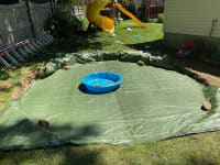 We put a small three foot wide plastic toddler pool in the hole on top if the green tarp.