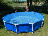 The pool, now standing on its own thanks to the frame and legs being inserted into its liner