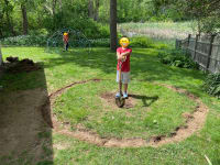 Our oldest son, holding a shovel, proud of the first bit of digging we did together