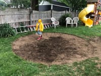 Our youngest son, walking in the circle of dirt where we removed the sod layer