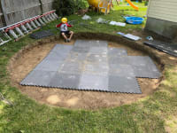 The hole, almost covered with interlocking rubber mats