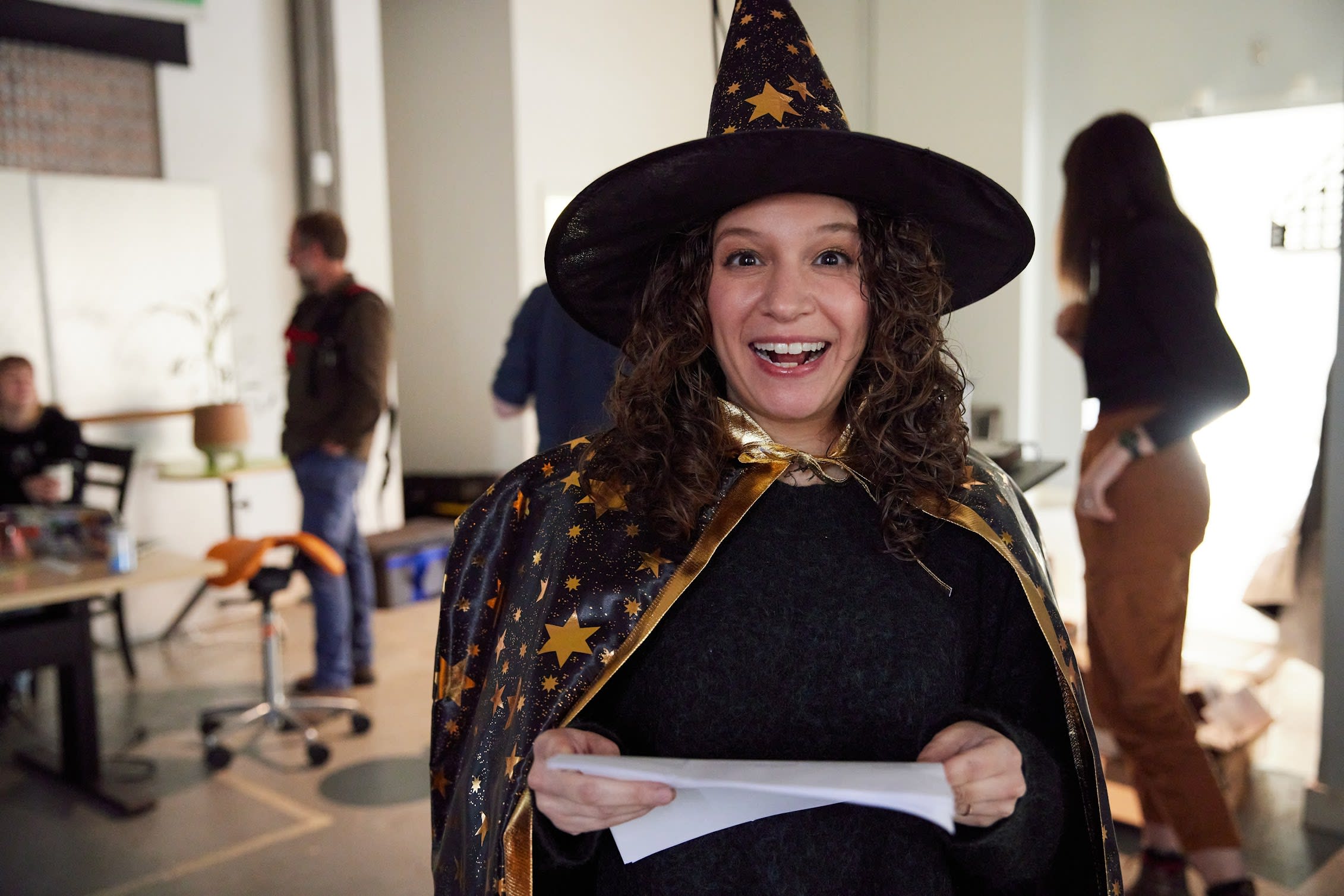 Marisa in a wizard hat making a funny face at the camera