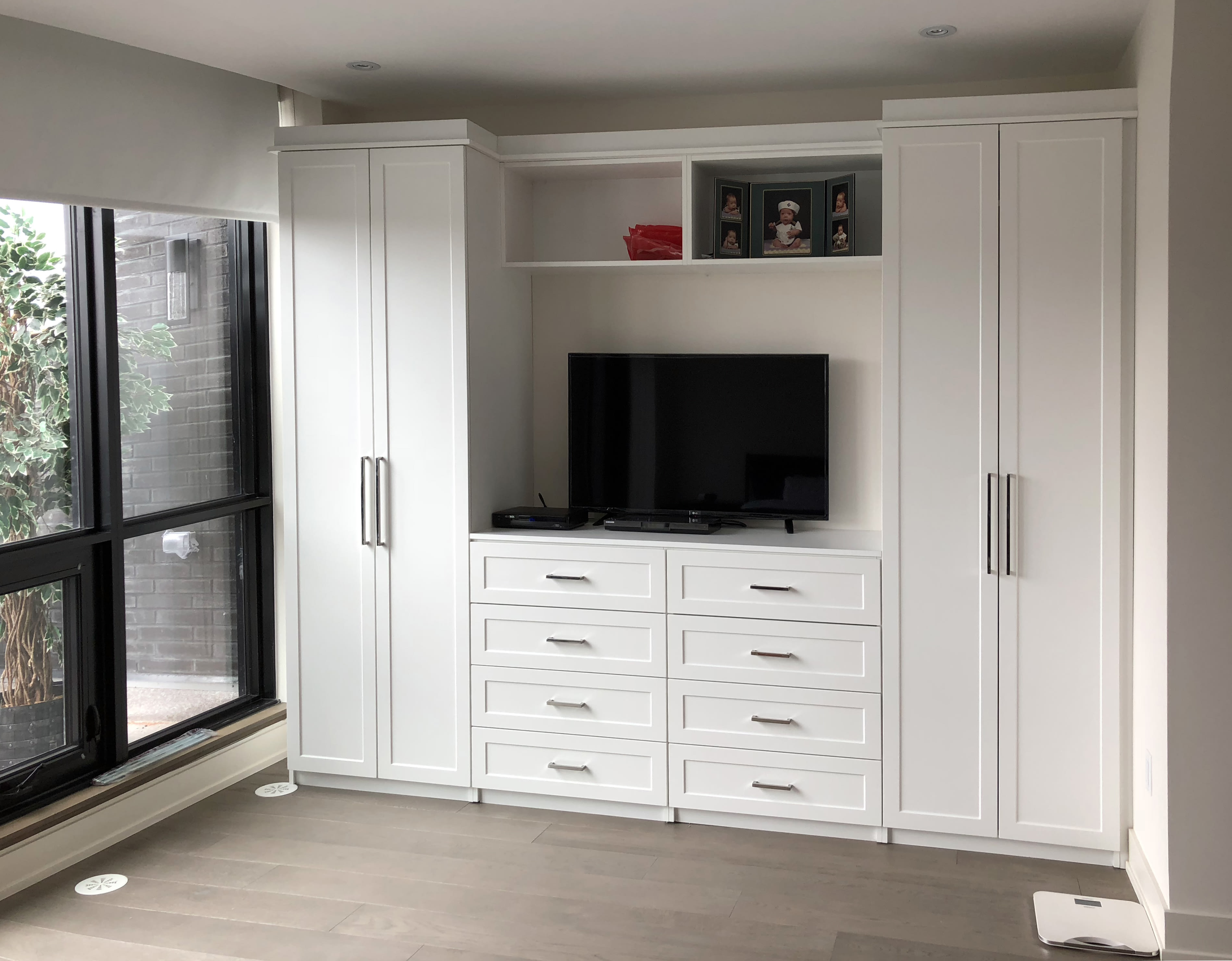 Modern white entertainment unit with TV and storage