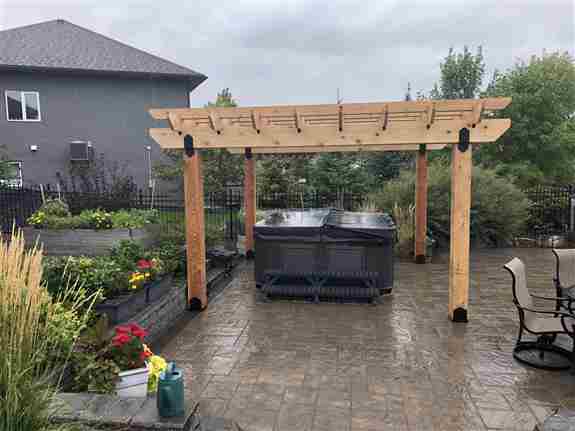 Custom cedar pergola structure to provide some summer shade on this beautiful Navaro paving stone patio
