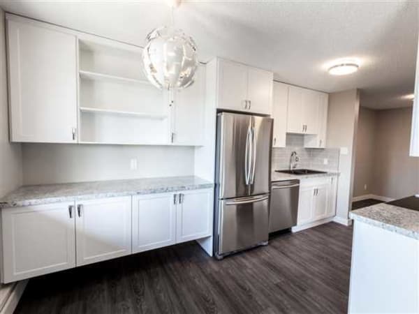 Our team worked with the client remotely to design and install custom white thermofoil cabinets and laminate countertops for this new kitchen project.