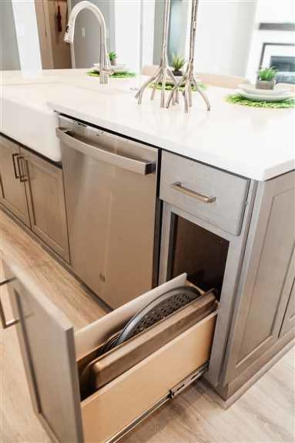 Even under the kitchen sink, custom two-level glide outs can store household chemicals, cleaning products, and other items typically found under a sink, while leaving room and access for the plumbing.