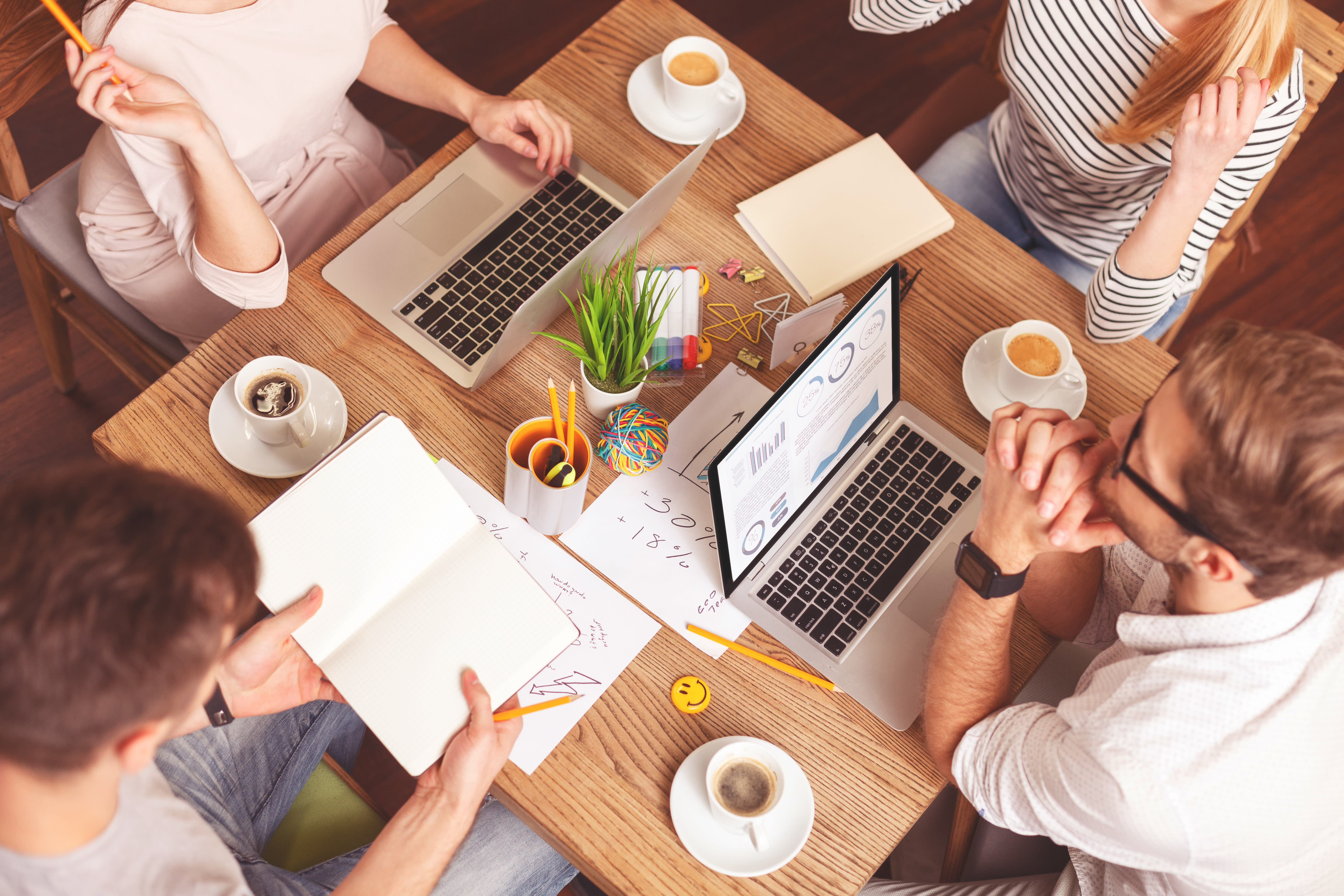 Smart four colleagues working in cooperation freelancers working together