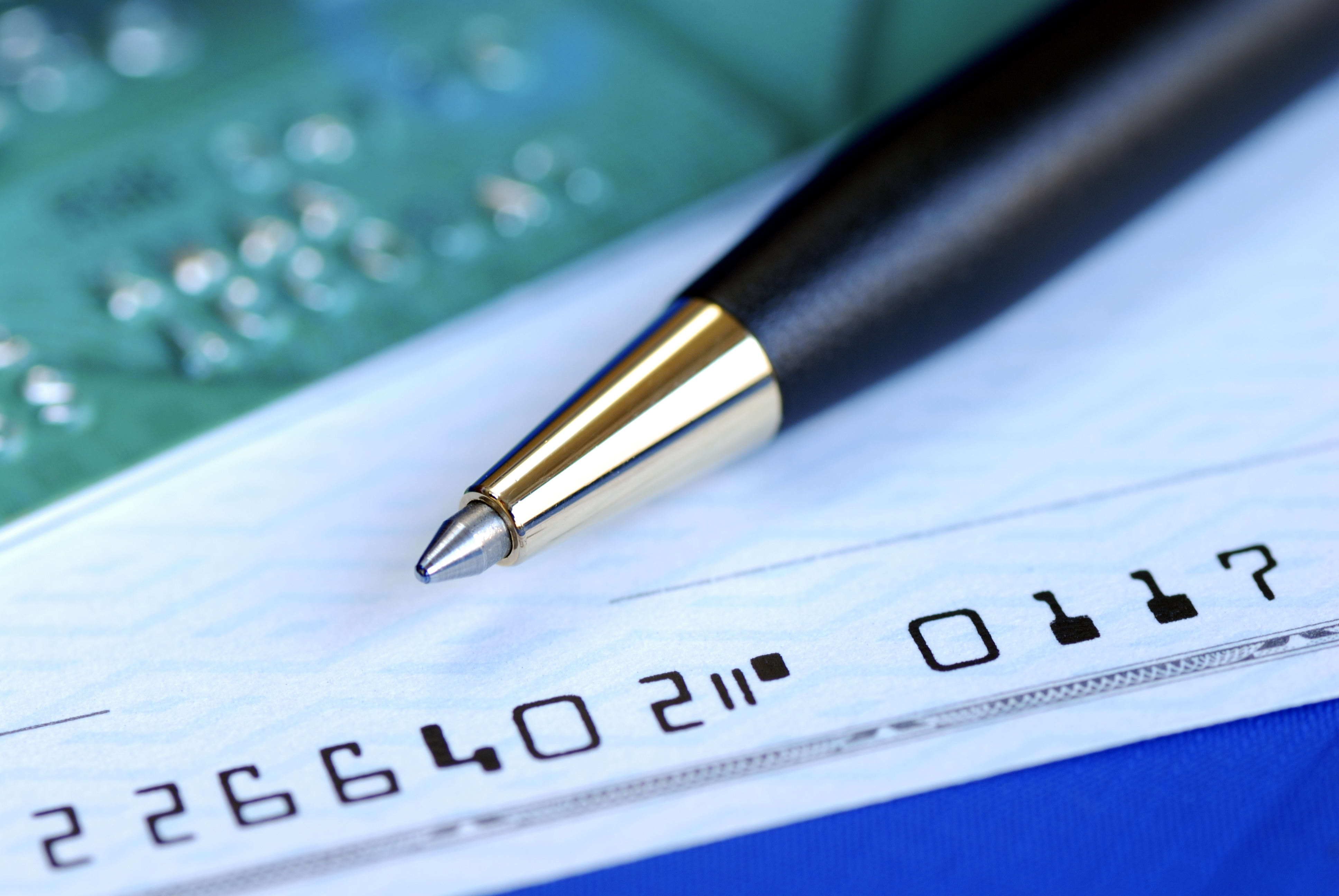 Write a check to pay the credit card bill isolated on blue get paid as a VBO