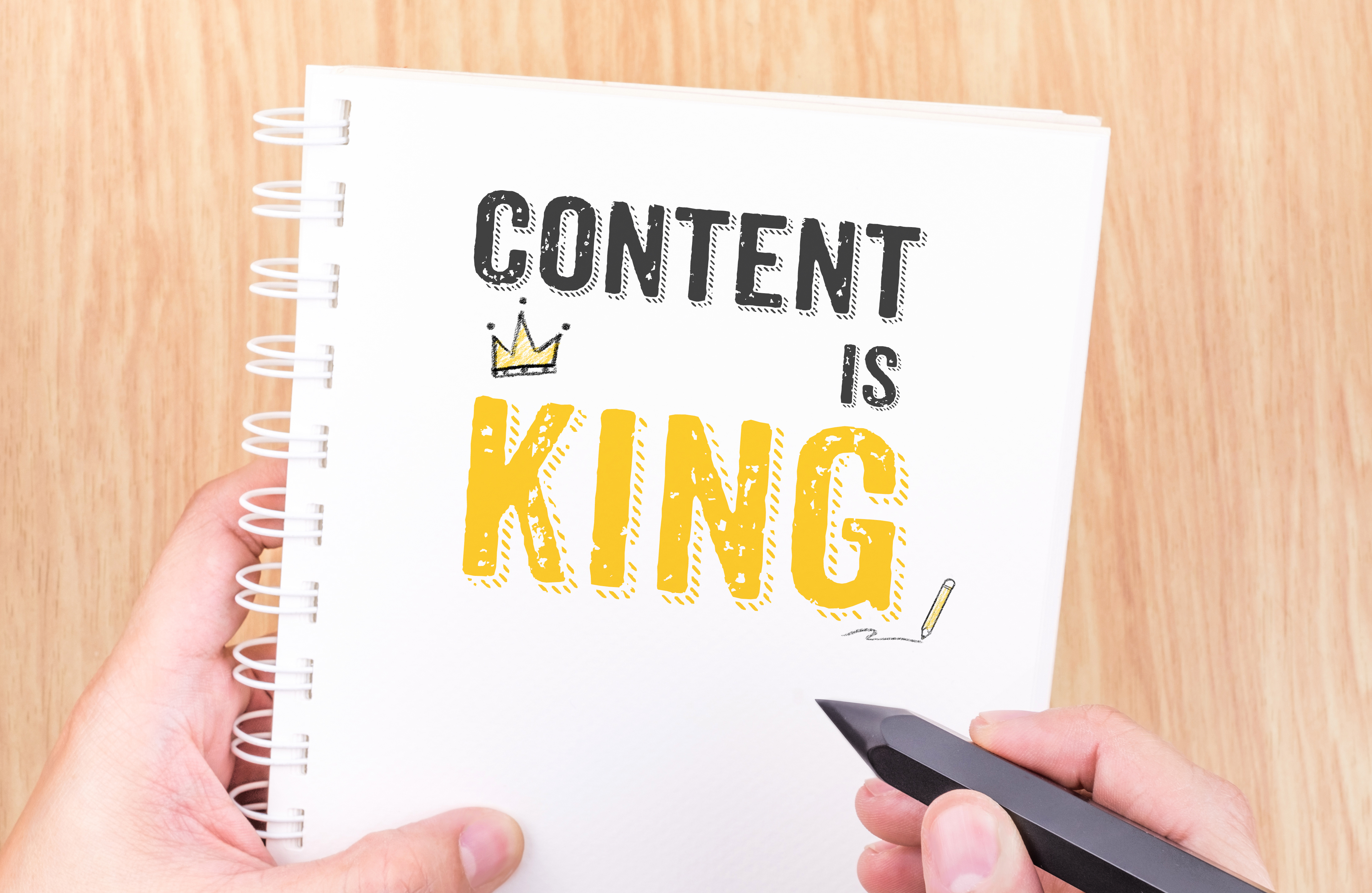Content is King work on white ring binder notebook with hand hol