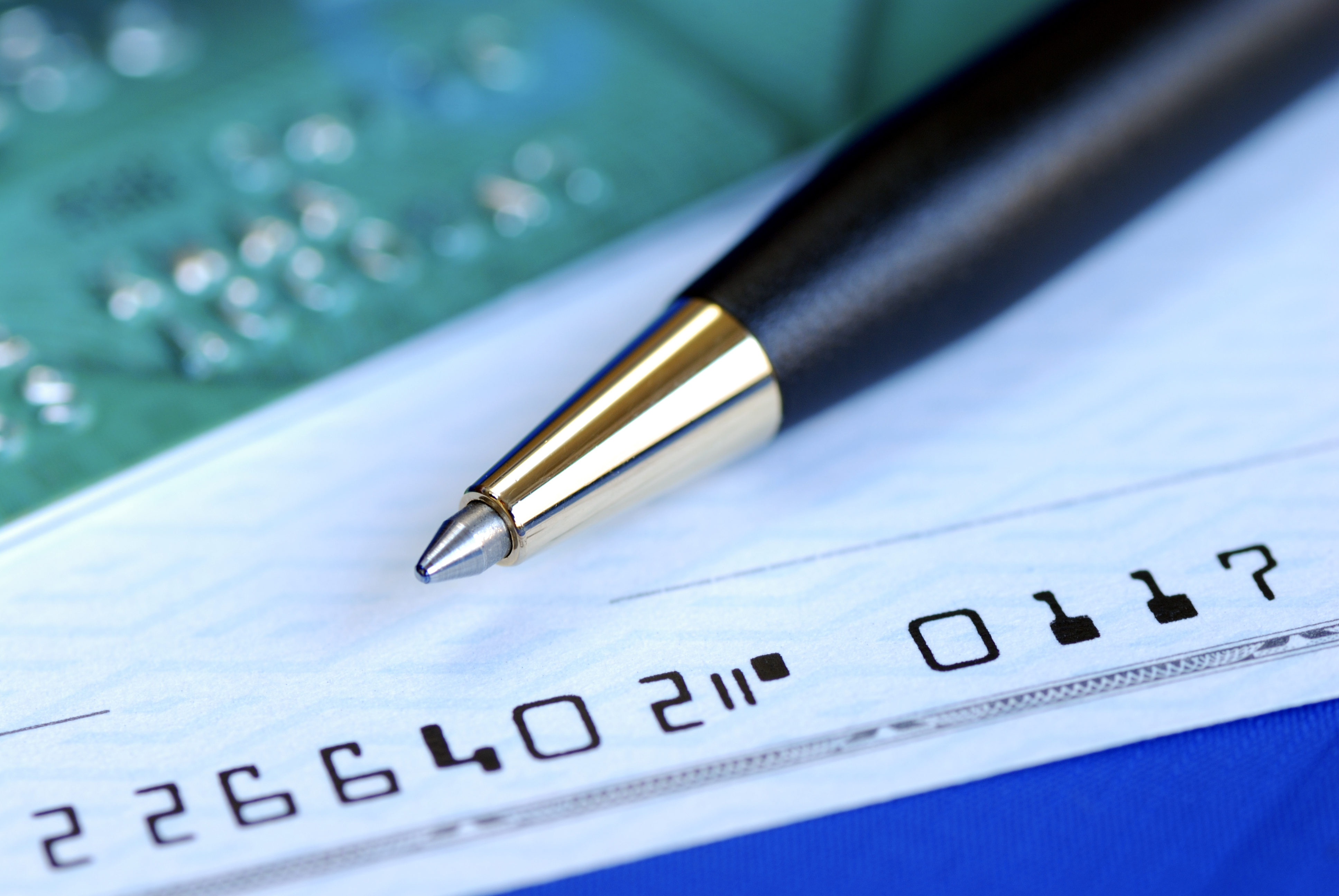 Write a check to pay the credit card bill isolated on blue