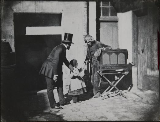 Henri Le Secq et un enfant donnant des aumônes à un broyeur d’organes