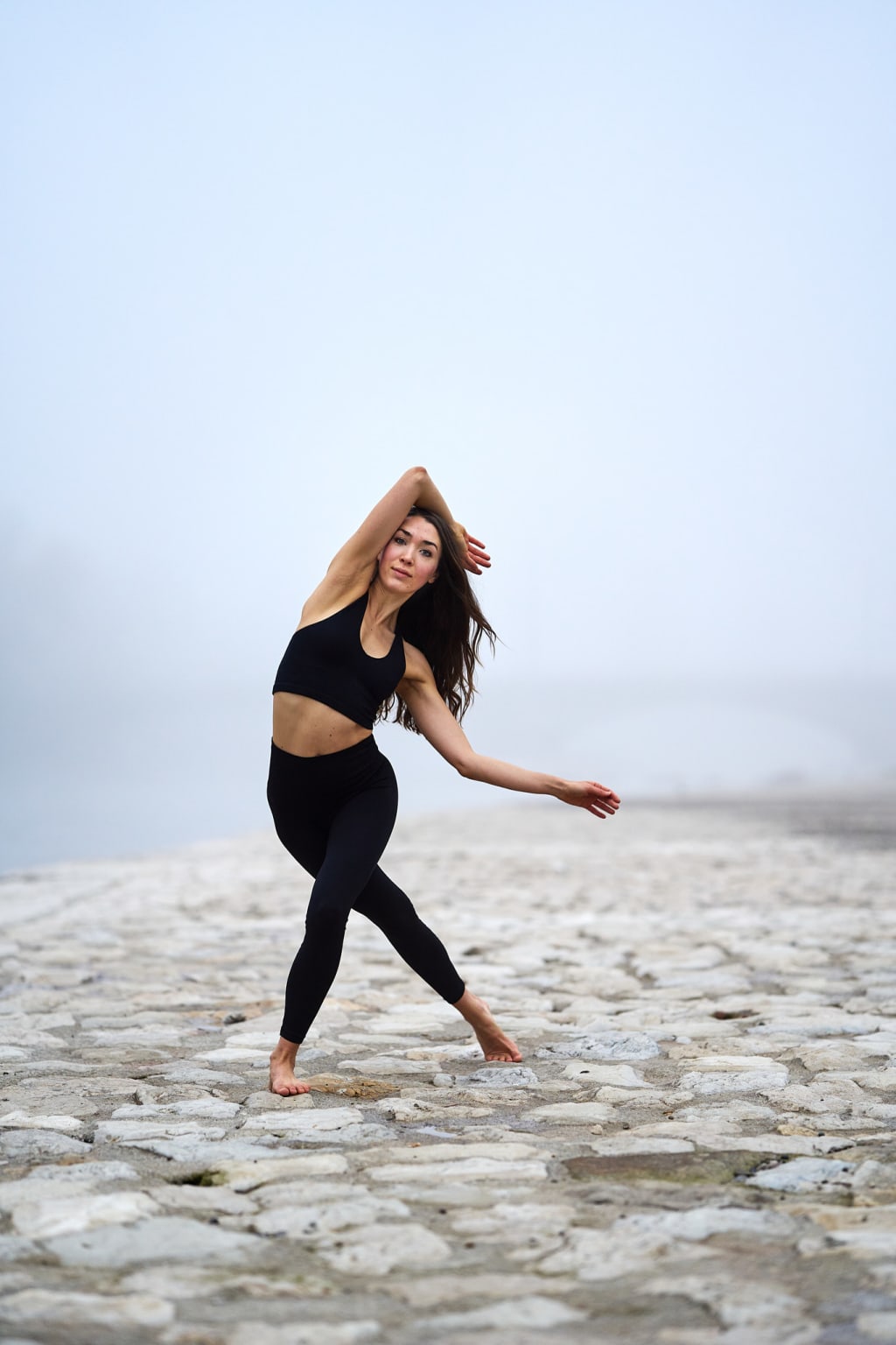 A foto of @franzi_orthey dancing at the Isar in Munich on a foggy morning