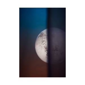 A creative view of the full moon through a curtain with an artistic focus effect.