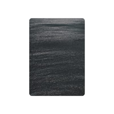 A calm and dark ocean surface reflecting intricate textures under moonlight. Peaceful and serene.