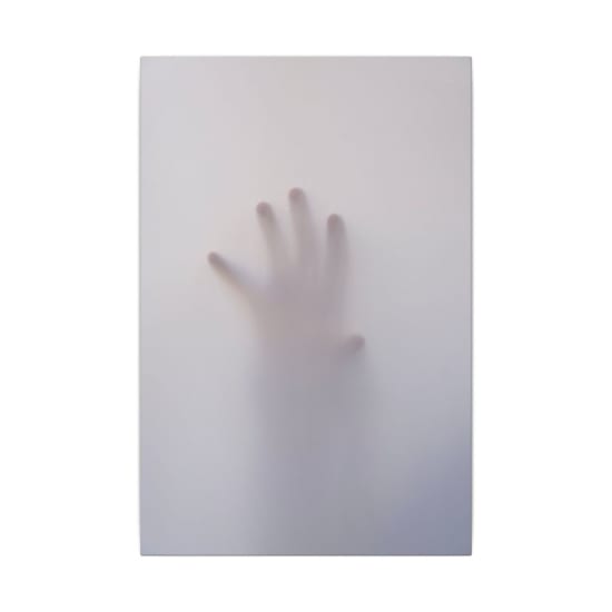 Eerie image of a hand reaching through a foggy surface, evoking mystery and suspense.