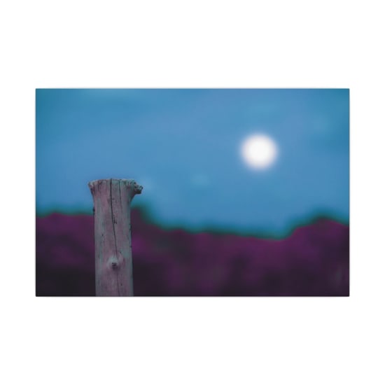 A solitary wooden post stands against a dreamy blurred night sky with a bright moon.