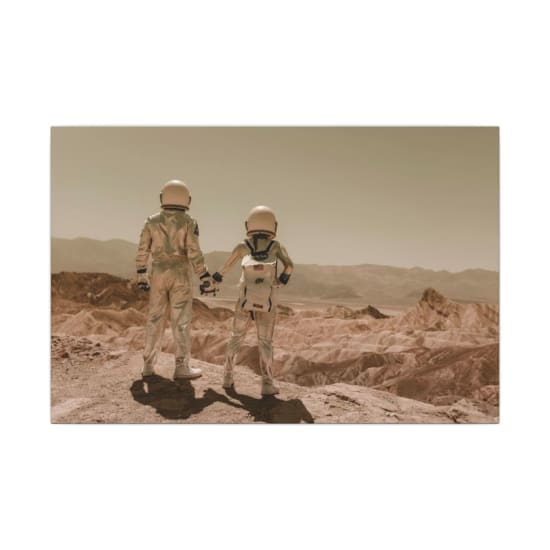 Two astronauts holding hands while exploring a desert terrain under a clear sky.