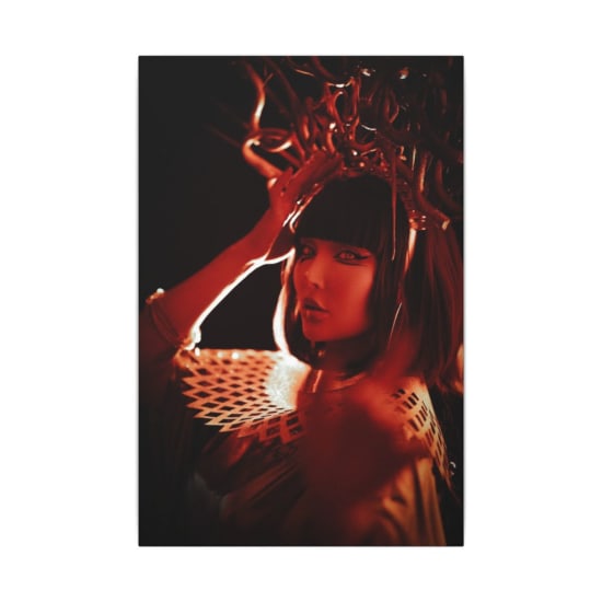 Striking portrait of a woman in elaborate costume with dramatic lighting.