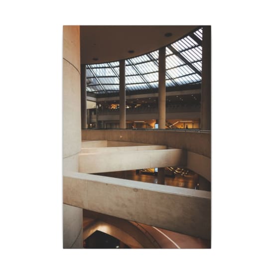 Spacious and sophisticated interior of a modern atrium with elegant curves and large windows.