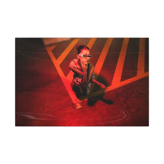 Cyberpunk-inspired fashion portrait with red lighting and fishnet sleeves.