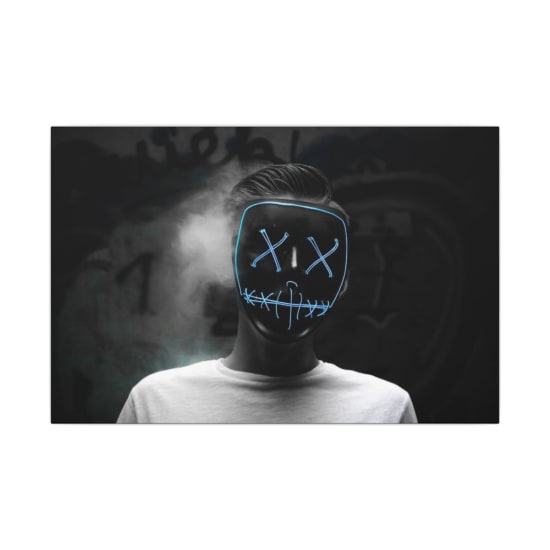 Dark portrait of a person wearing a glowing LED mask creating a Halloween vibe.