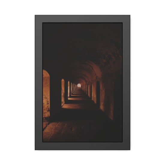 Explore a dark, atmospheric tunnel with arches leading to a distant light.
