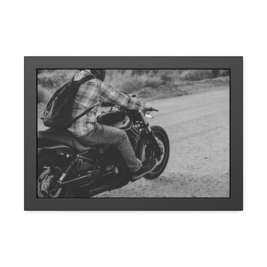 A motorcyclist rides a motorbike on a rugged desert road in Joshua Tree, CA.