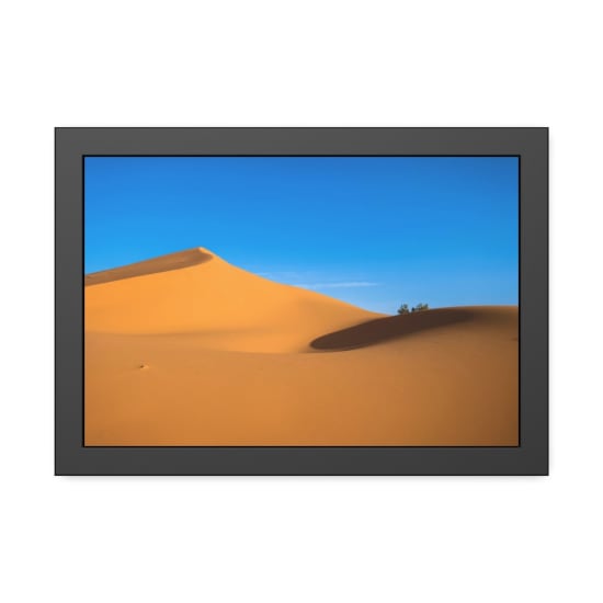 Stunning golden sand dunes with clear blue sky at Ksar Tanamouste, Morocco.