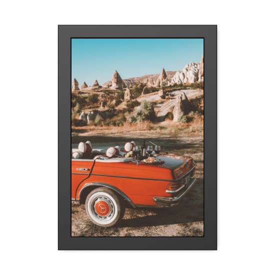 A vintage convertible parked near Cappadocia's rock formations, featuring a picnic setup with wine.