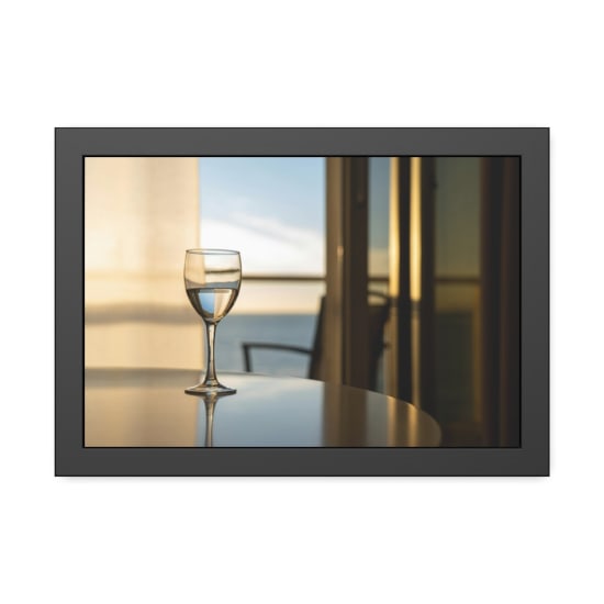 A glass of wine on a table with a stunning ocean view through a window, captured indoors.
