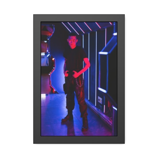 Young Asian man in a futuristic setting with vibrant neon lighting.