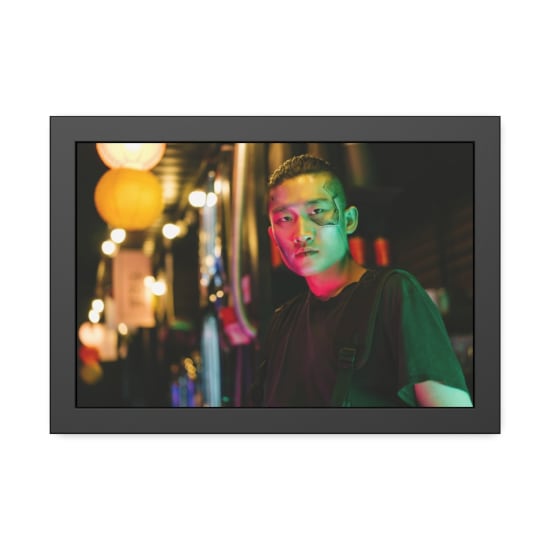 A futuristic portrait of a man in neon lighting, embodying cyberpunk style and fashion.