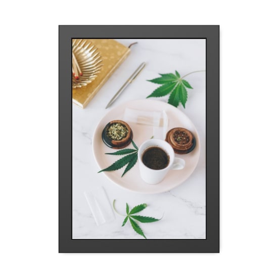 Aesthetic arrangement of coffee and cannabis leaves on a marble surface, ideal for lifestyle themes.