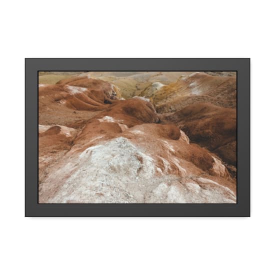 Explore the rugged arid landscape with vibrant sandstone formations and unique geological textures.